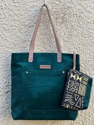 A dark teal Njoo Dada tote bag with a matching printed pouch.